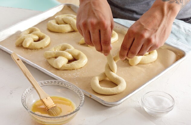Someone shaping pretzel dough