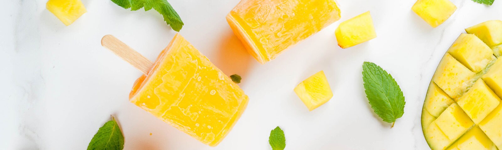 Cut up fruit freezed into popsicles on a stick