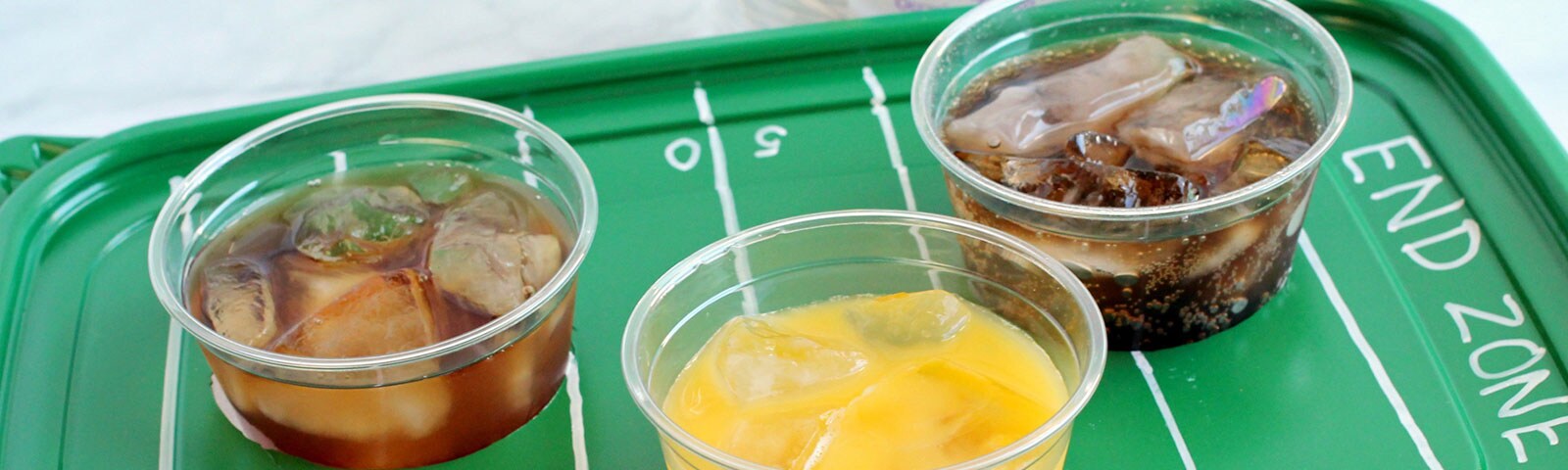 DIY football field drink tray holding three different drinks