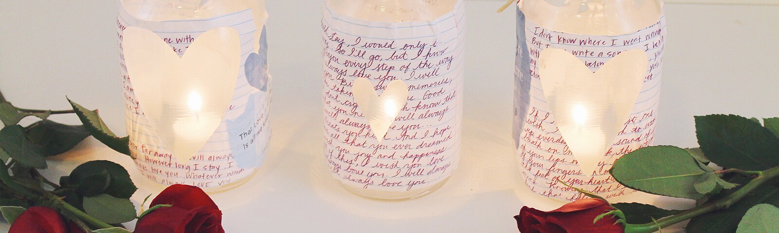 Heart cut out love notes on mason jars