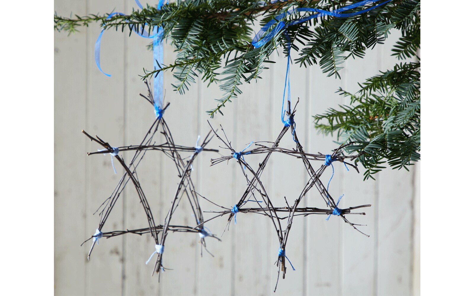 Holiday star made out of twigs tied with ribbon