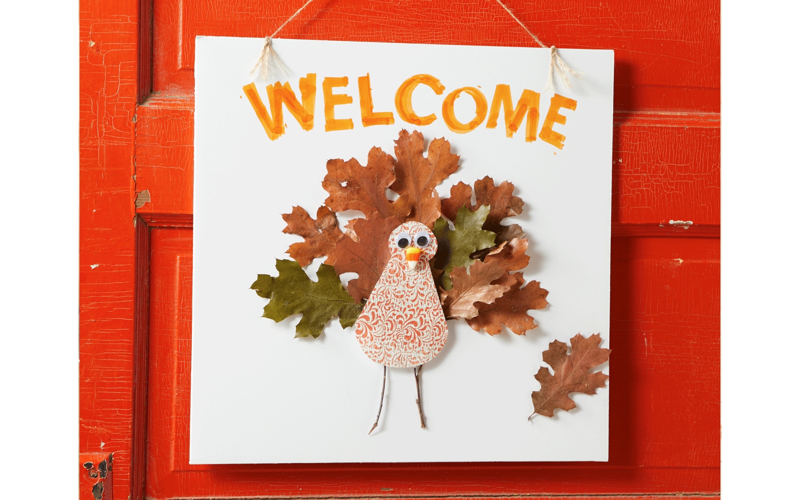 Turkey made out of paper for Thanksgiving and hung on red door